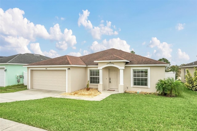 single story home with a garage and a front lawn