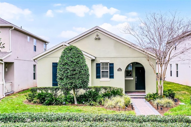 view of front of house featuring a front yard and stucco siding