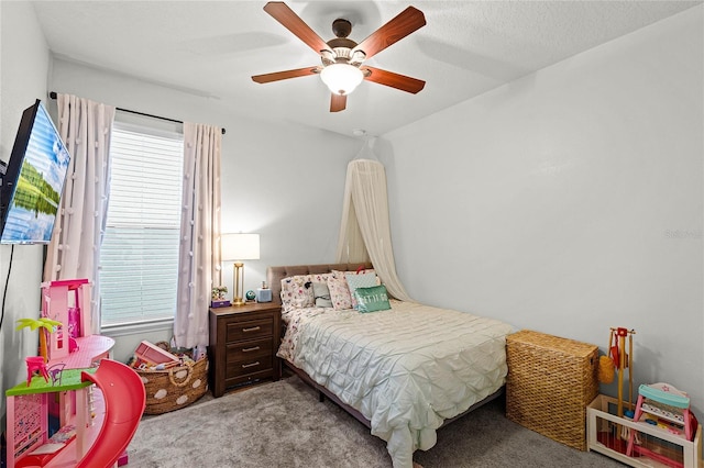 bedroom featuring a ceiling fan, light carpet, and multiple windows