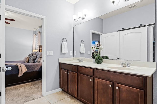 bathroom featuring a sink, tile patterned flooring, visible vents, and connected bathroom