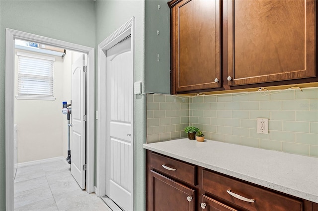 bathroom featuring backsplash, baseboards, and tile patterned floors