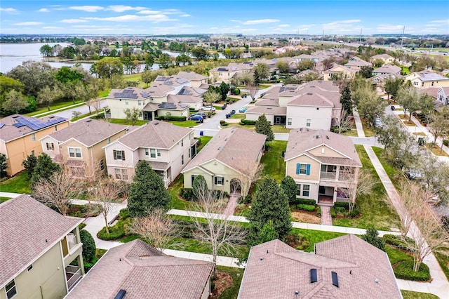 birds eye view of property with a water view and a residential view