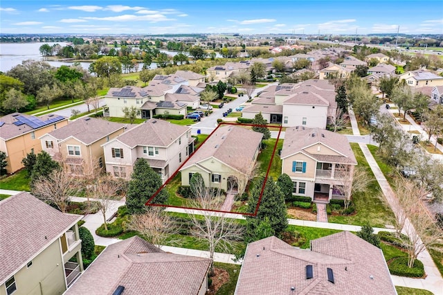 drone / aerial view with a water view and a residential view