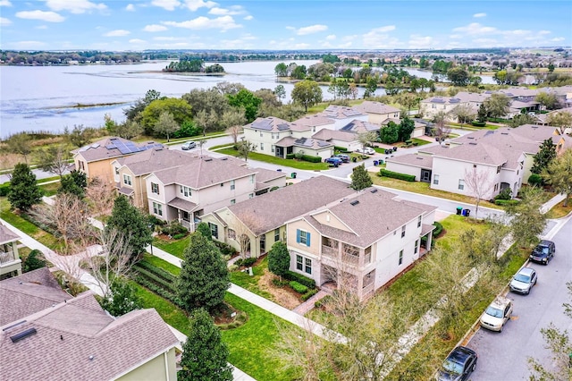 drone / aerial view with a residential view and a water view