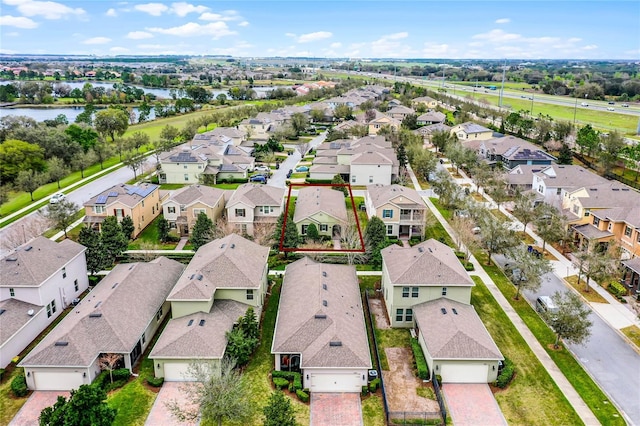 birds eye view of property featuring a water view and a residential view