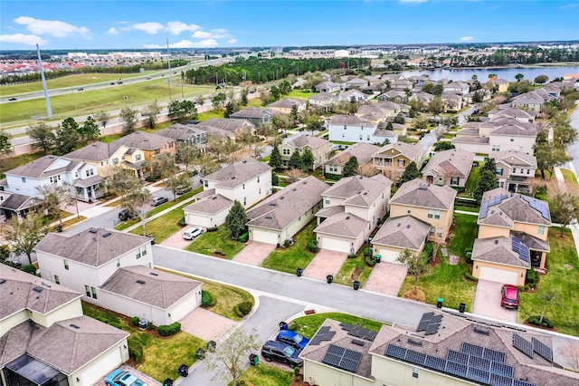 drone / aerial view featuring a water view and a residential view