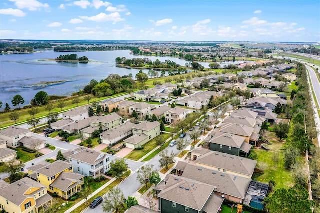 drone / aerial view featuring a water view and a residential view