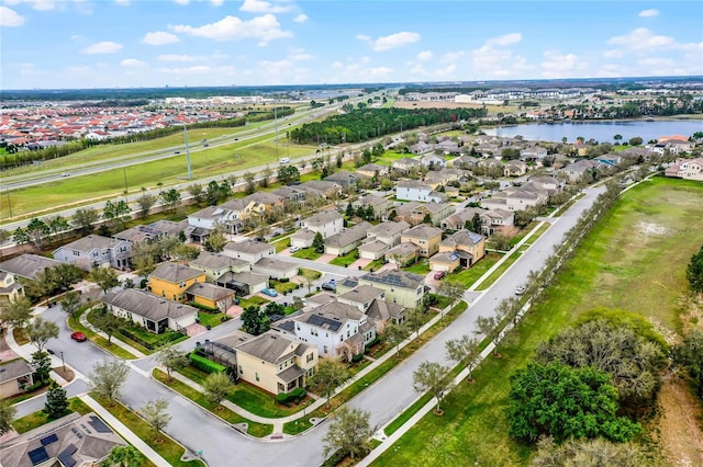 bird's eye view with a water view and a residential view