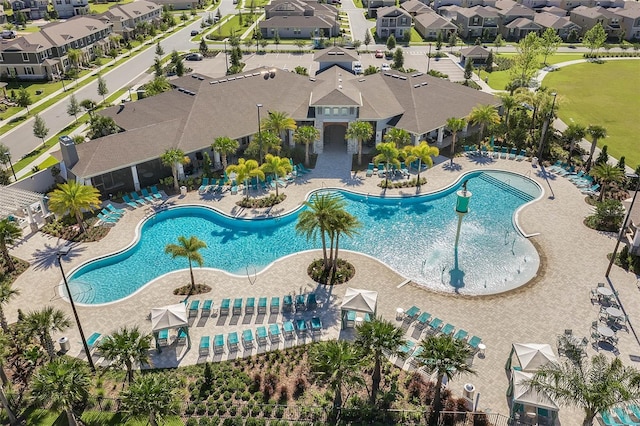 pool with a patio area and a residential view