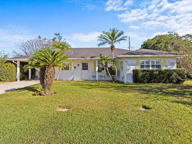 ranch-style home featuring a carport and a front yard