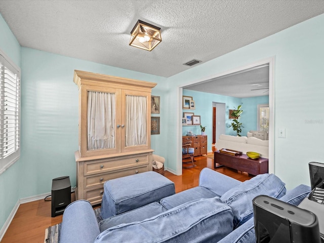 bedroom featuring a textured ceiling and wood-type flooring