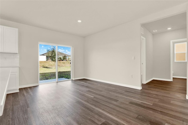 unfurnished living room with plenty of natural light and dark wood-type flooring