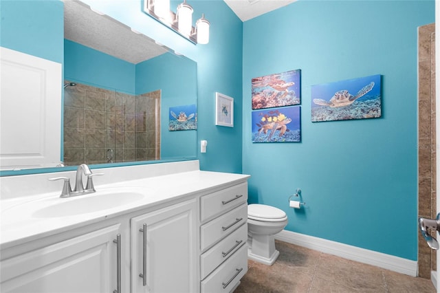 full bath with toilet, a shower stall, vanity, baseboards, and tile patterned floors