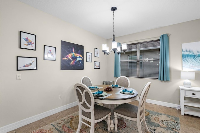 dining room with a chandelier, tile patterned flooring, and baseboards
