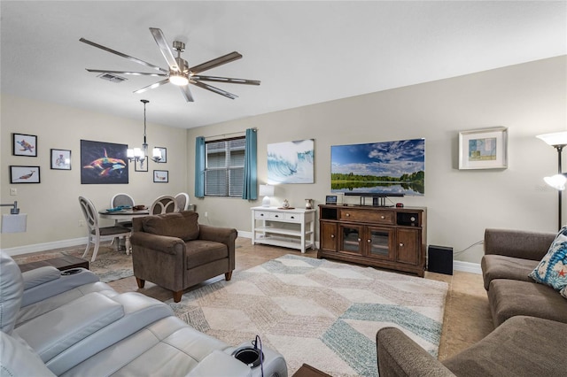 living area featuring baseboards, visible vents, and a chandelier