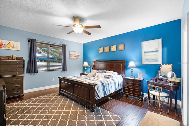 bedroom featuring a ceiling fan, baseboards, dark wood finished floors, and a textured ceiling