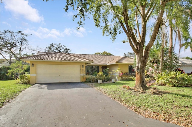 view of front of home featuring a garage and a front yard