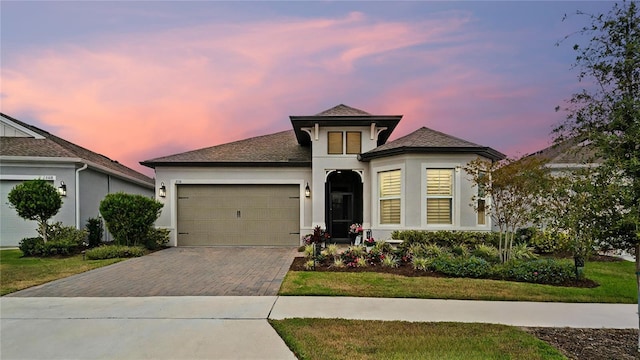 view of front of house with a garage and a lawn