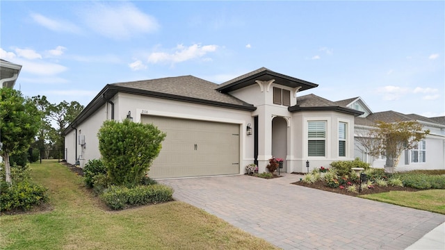 view of front of property featuring a garage and a front lawn