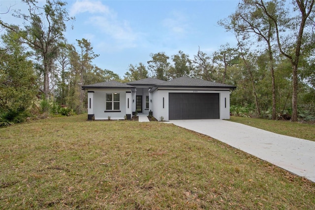 view of front of property with a garage and a front lawn