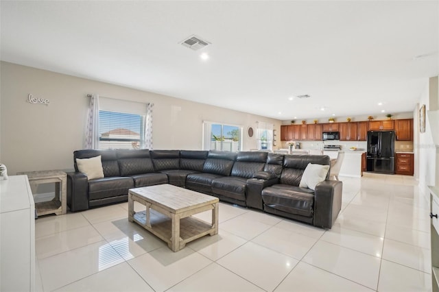 living room featuring recessed lighting, visible vents, and light tile patterned flooring