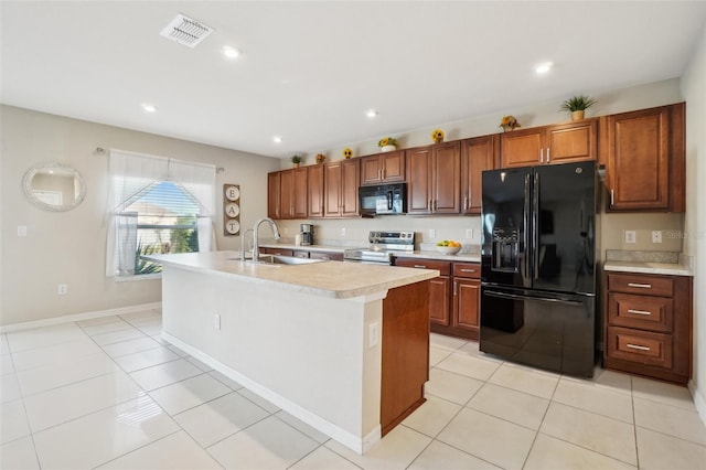 kitchen featuring light tile patterned flooring, a sink, visible vents, light countertops, and black appliances