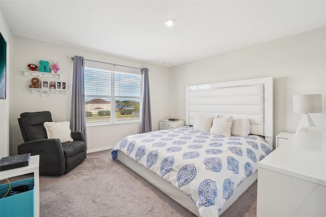 bedroom with carpet floors and baseboards