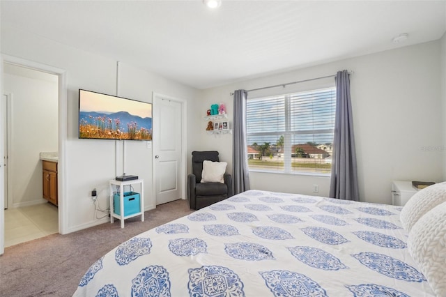 carpeted bedroom featuring connected bathroom