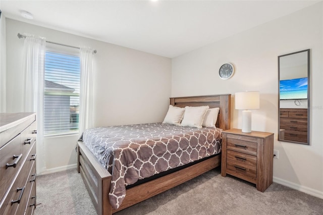 bedroom with light carpet and baseboards