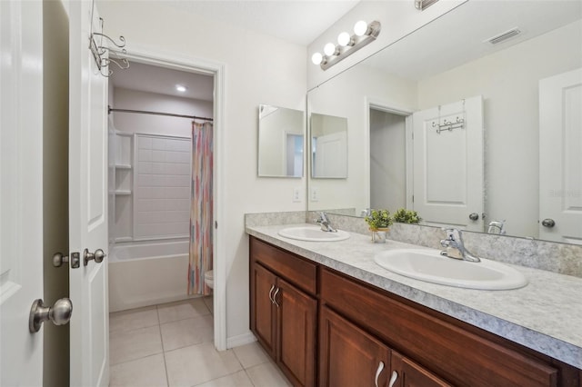 full bath featuring double vanity, tile patterned flooring, visible vents, and a sink