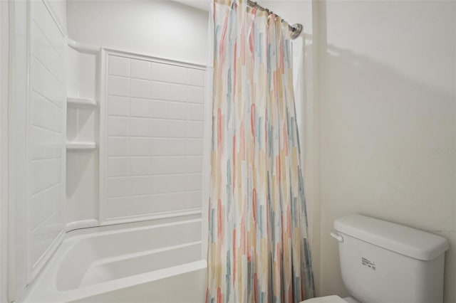 bathroom featuring toilet and shower / bath combo with shower curtain