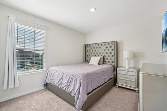 bedroom with multiple windows, carpet flooring, and baseboards