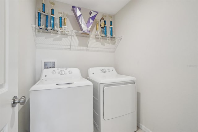 laundry room featuring laundry area, baseboards, and washer and dryer