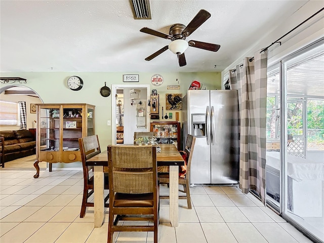 dining space featuring ceiling fan and light tile patterned floors