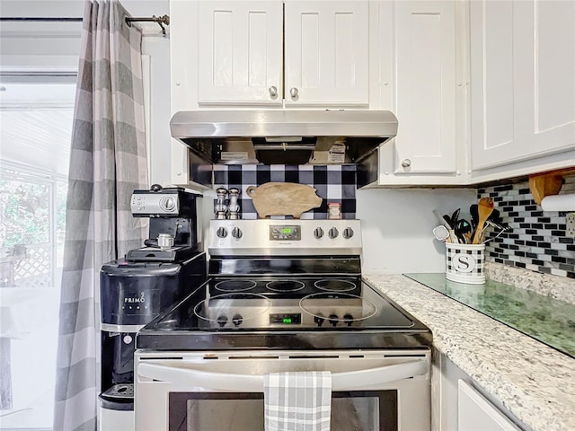 kitchen featuring white cabinetry, ventilation hood, stainless steel electric range oven, tasteful backsplash, and light stone counters