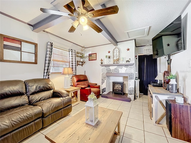 tiled living room with a wood stove, ceiling fan, ornamental molding, and beam ceiling