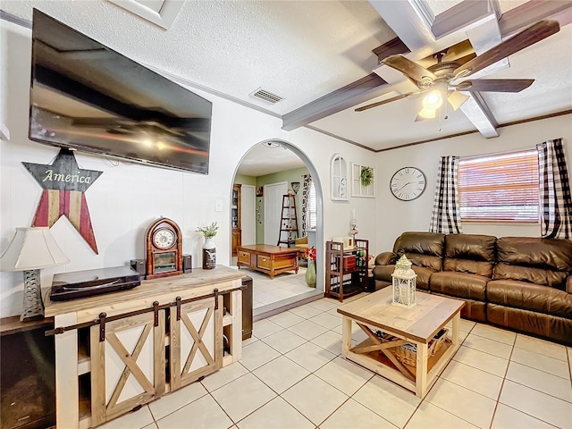 tiled living room featuring ceiling fan, beamed ceiling, and a textured ceiling