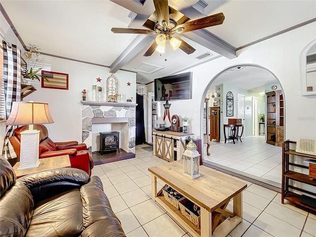 living room with light tile patterned floors, crown molding, and beamed ceiling