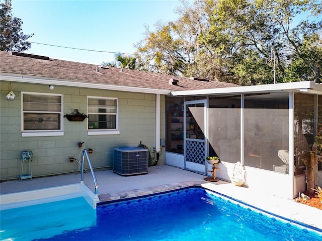 rear view of property featuring central AC unit, a patio, and a sunroom