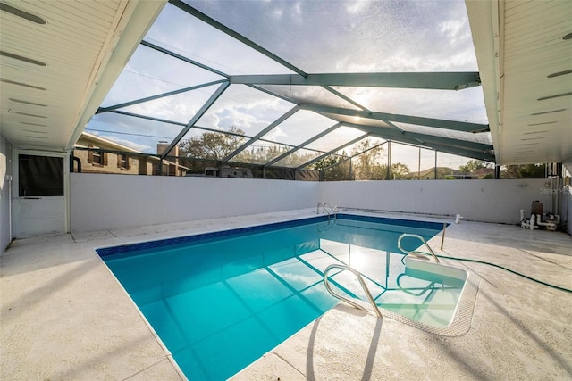 view of swimming pool with a fenced in pool, glass enclosure, and a patio