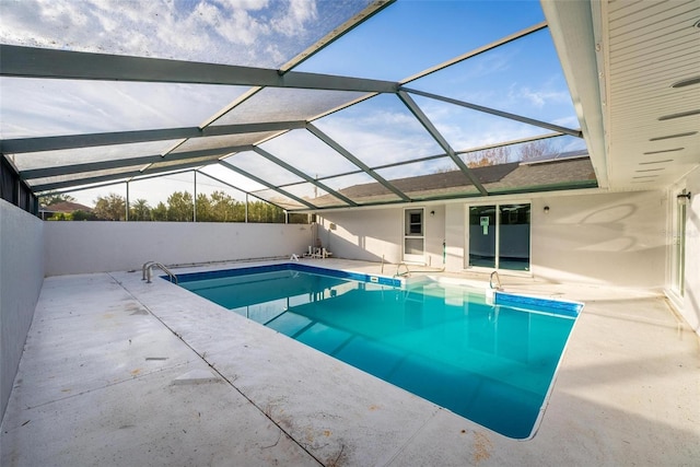 view of pool featuring a patio area, glass enclosure, and a fenced in pool