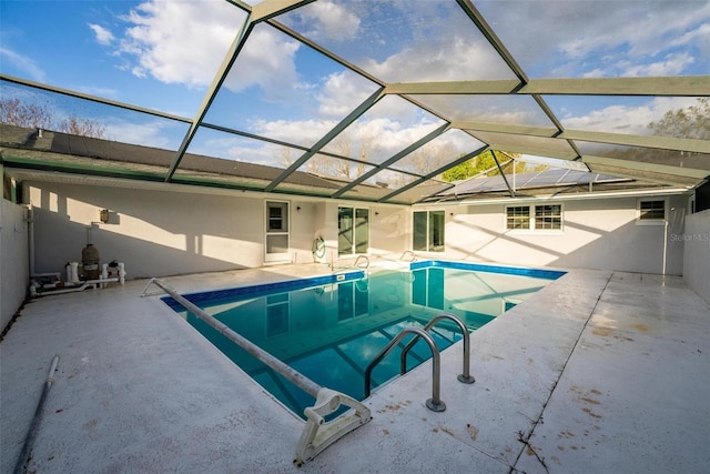 outdoor pool featuring a patio area and a lanai