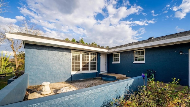 exterior space with fence and stucco siding