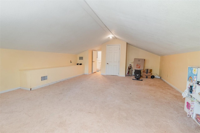 bonus room with lofted ceiling, baseboards, visible vents, and carpet flooring