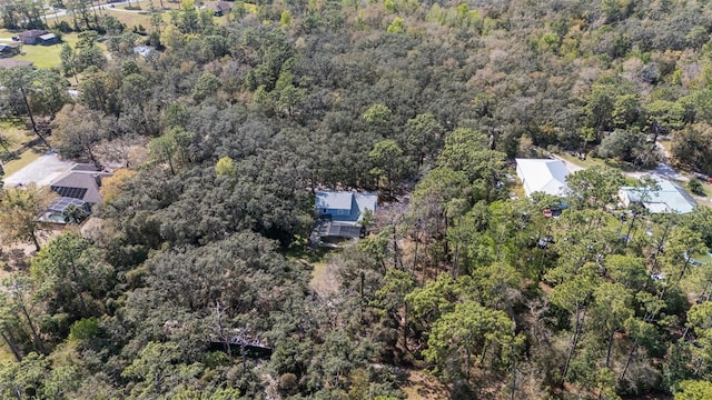 birds eye view of property with a wooded view