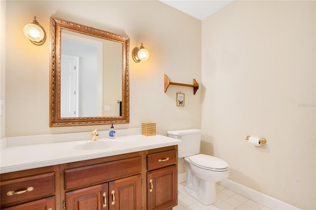 half bath featuring tile patterned flooring, vanity, toilet, and baseboards