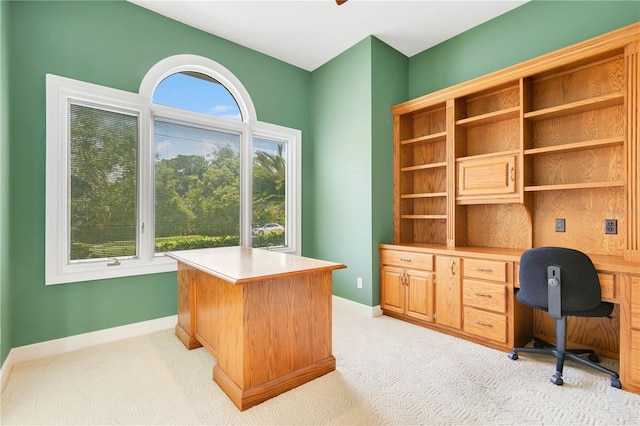 office area featuring baseboards and light colored carpet