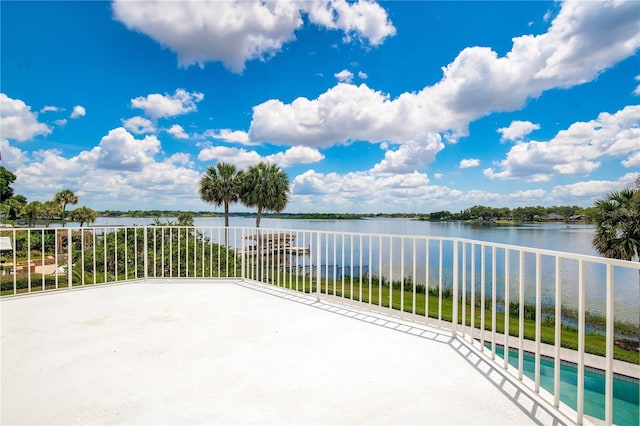 view of patio featuring a water view and a pool