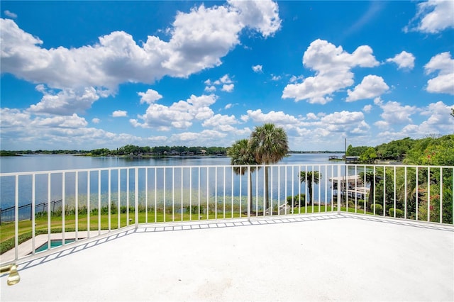 view of patio featuring a water view and a balcony