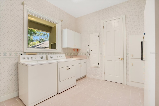 laundry area with cabinet space, washer and clothes dryer, baseboards, and wallpapered walls